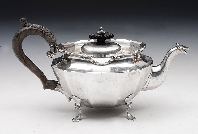 Appraisal: A SILVER TEAPOT with twelve panelled sides sunken domed lid