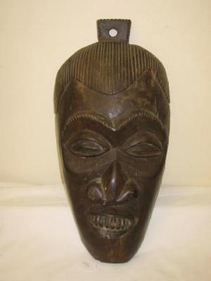 Appraisal: A TRIBAL WOOD MASK in ebony with carved eyes wide