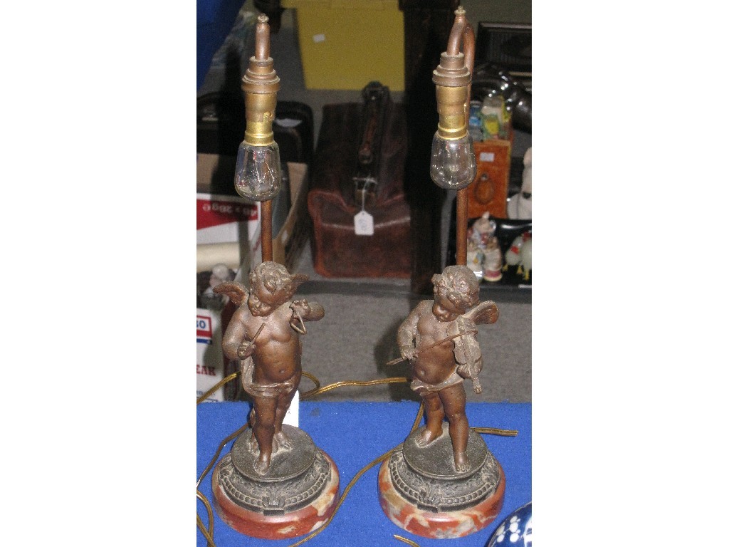 Appraisal: Pair of Spelter cherub table lamps one playing the triangle