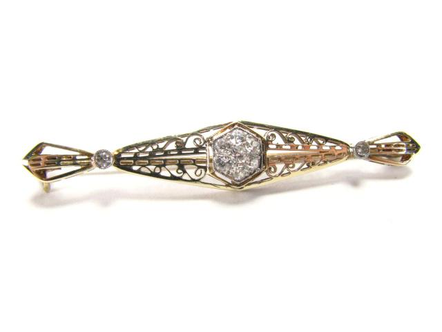 Appraisal: K yellow gold filigree pin with seven diamond center and