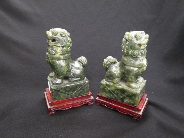 Appraisal: Pair of Chinese Carved Foo Dog Bookendsmale and female deep