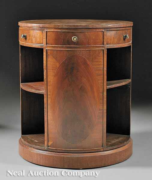 Appraisal: A Georgian-Style Mahogany Library Stand circular top drawers over doors