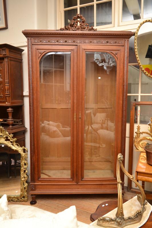 Appraisal: A LOUIS STYLE WALNUT GLAZED TWO DOOR BOOKCASE SHELVES IN