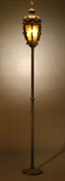 Appraisal: A Continental patinated metal torchere A Continental patinated metal torchere