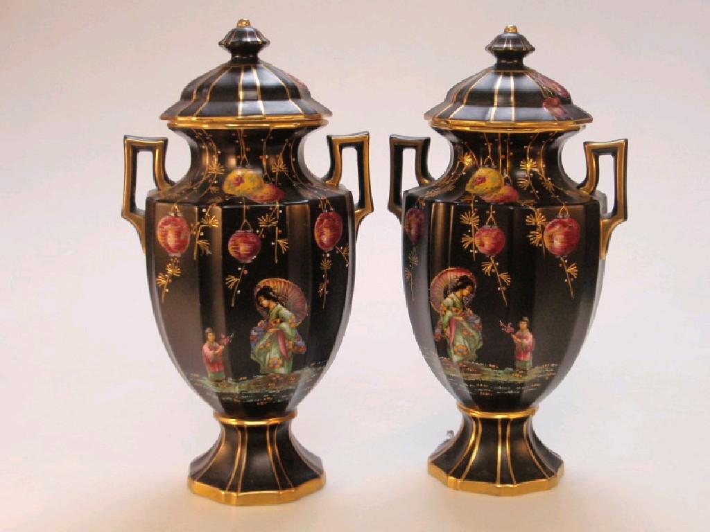 Appraisal: A pair of lidded two-handled jars black background decorated with