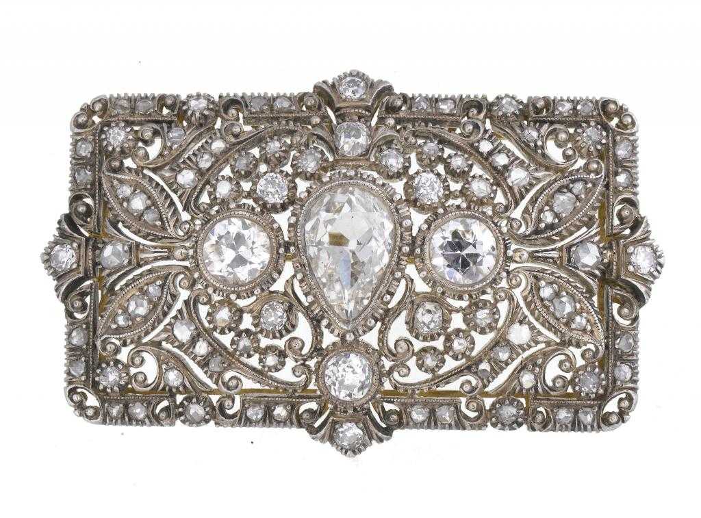 Appraisal: A DIAMOND BROOCH the domed rectangular openwork plaque centred by