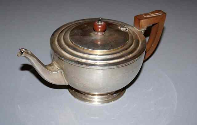 Appraisal: A 'S SILVER TEAPOT with stepped geometric design wooden handle