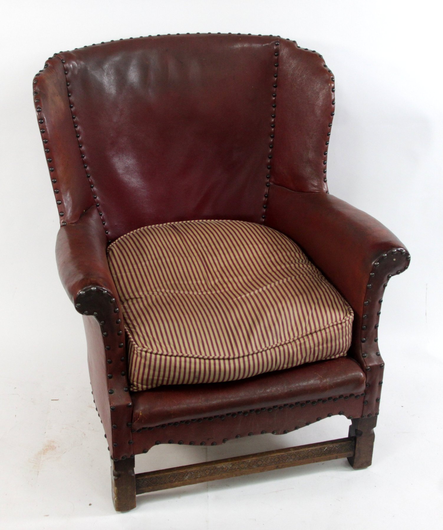 Appraisal: Four leather upholstered wing armchairs the turned front legs united