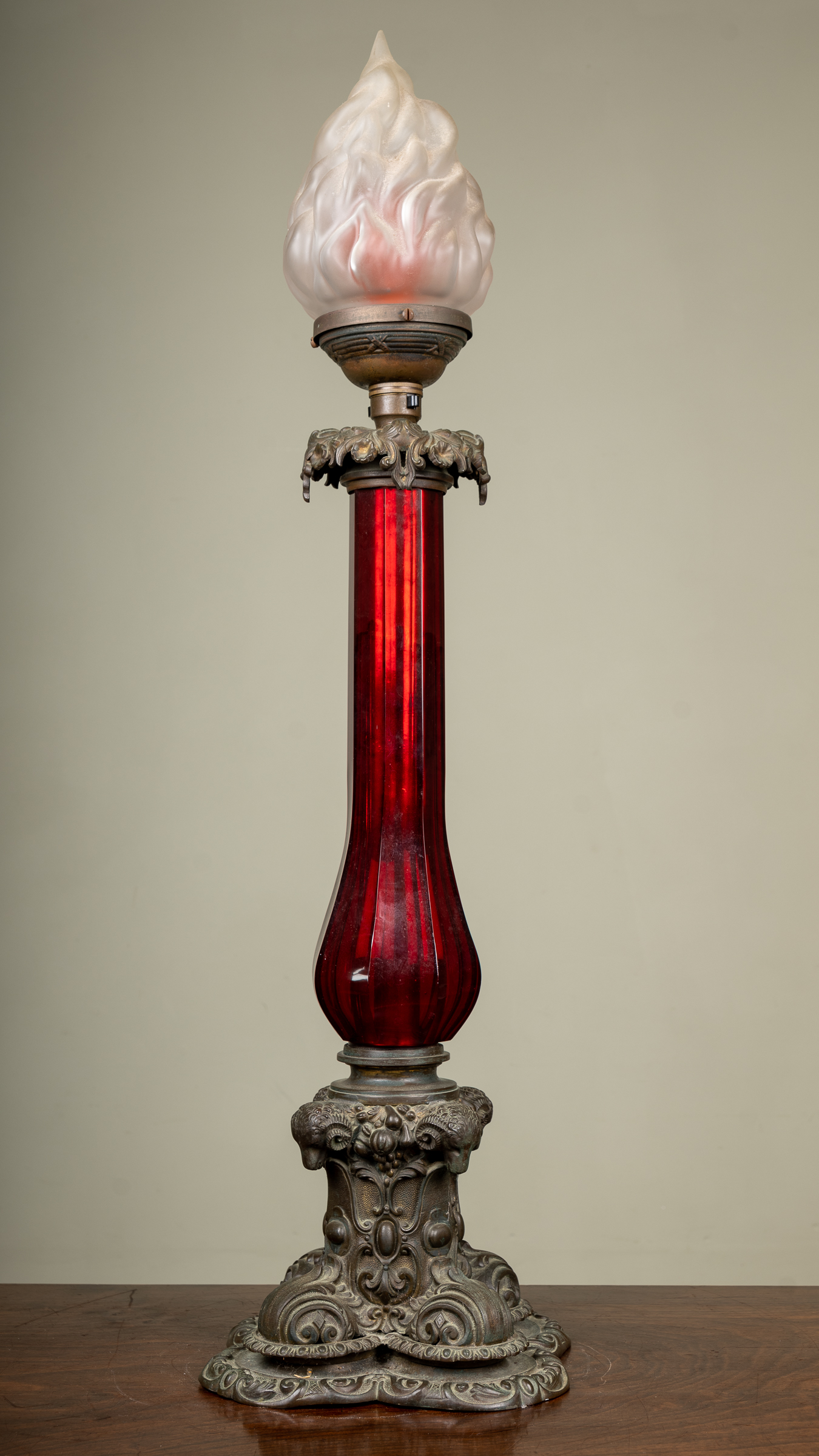 Appraisal: A th century bronze and red glass oil lamp base