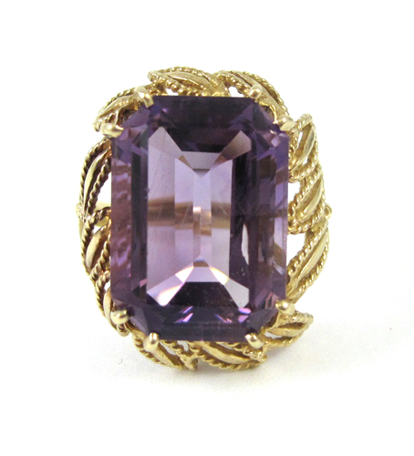 Appraisal: AMETHYST AND FOURTEEN KARAT GOLD RING set with a large