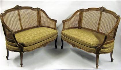 Appraisal: Pair of Louis XV style carved walnut and caned setteesEach