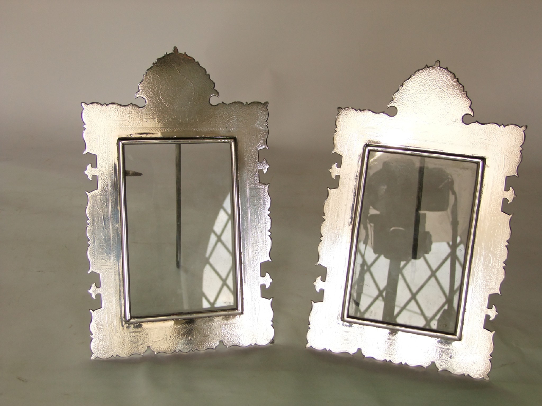 Appraisal: A pair of Eastern white metal photograph frames of shaped