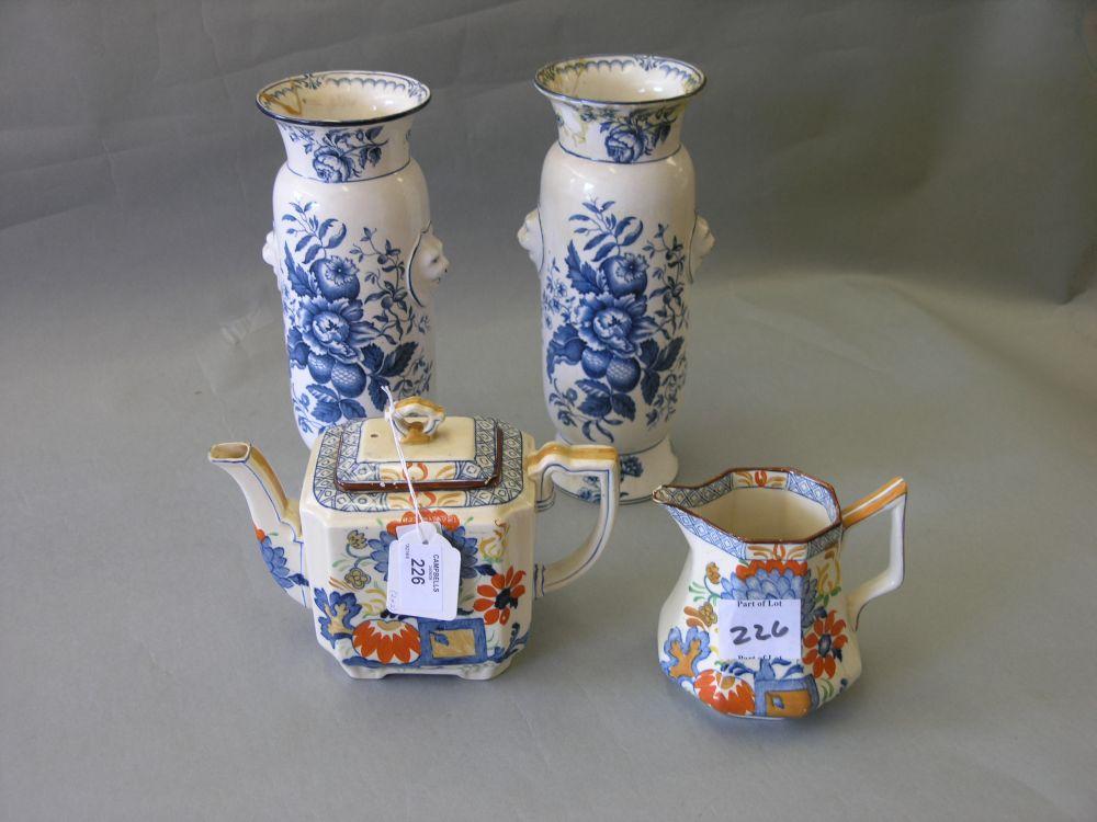 Appraisal: A pair of unusual Booth's earthenware vases painted with fruit