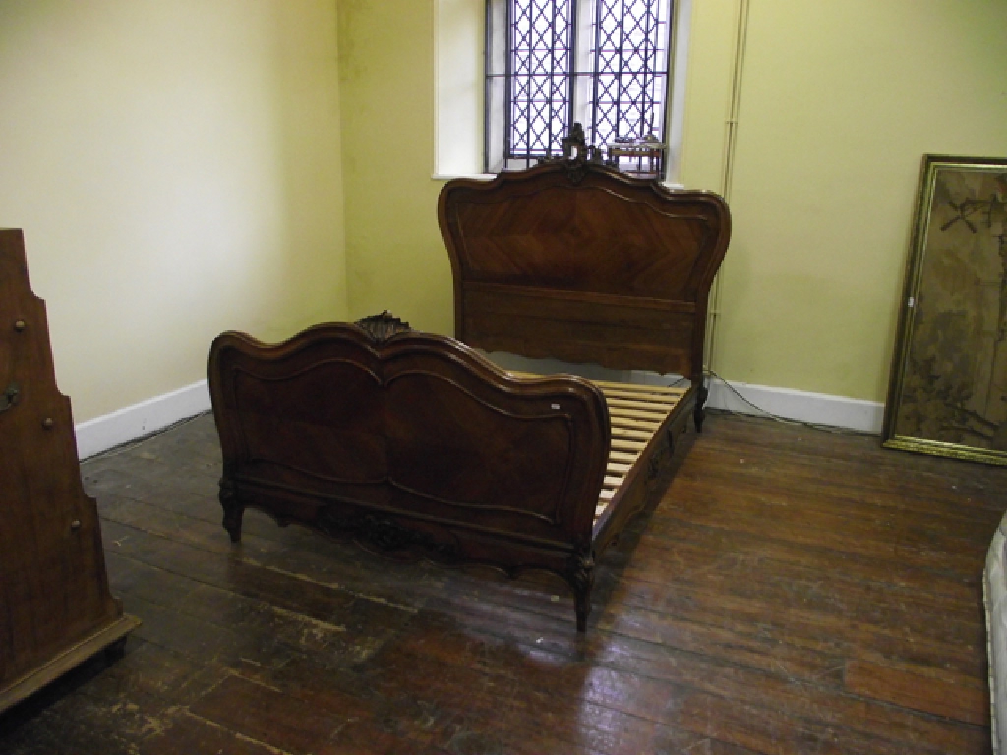 Appraisal: A th century walnut bedstead with shaped outline carved and