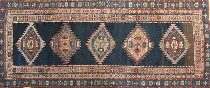 Appraisal: CAUCASIAN RUG Worked with zig-zag-enclosed hexagons on a cobalt ground