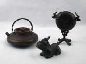 Appraisal: A Chinese bronze kettle with removable infuser and swing handle