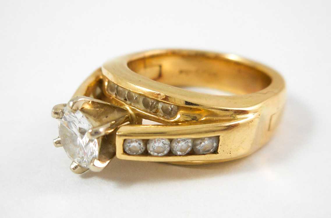 Appraisal: DIAMOND AND FOURTEEN KARAT GOLD RING The yellow gold Superfit