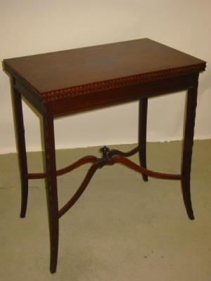 Appraisal: A MAHOGANY FOLDING CARD TABLE the oblong quarter veneered swivel