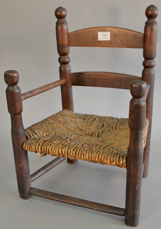 Appraisal: Primitive ladder back child's armchair with rush seat in original