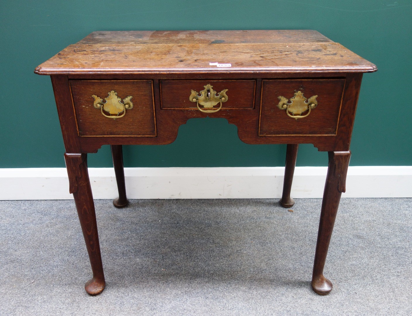 Appraisal: A mid th century oak lowboy with thee frieze drawers