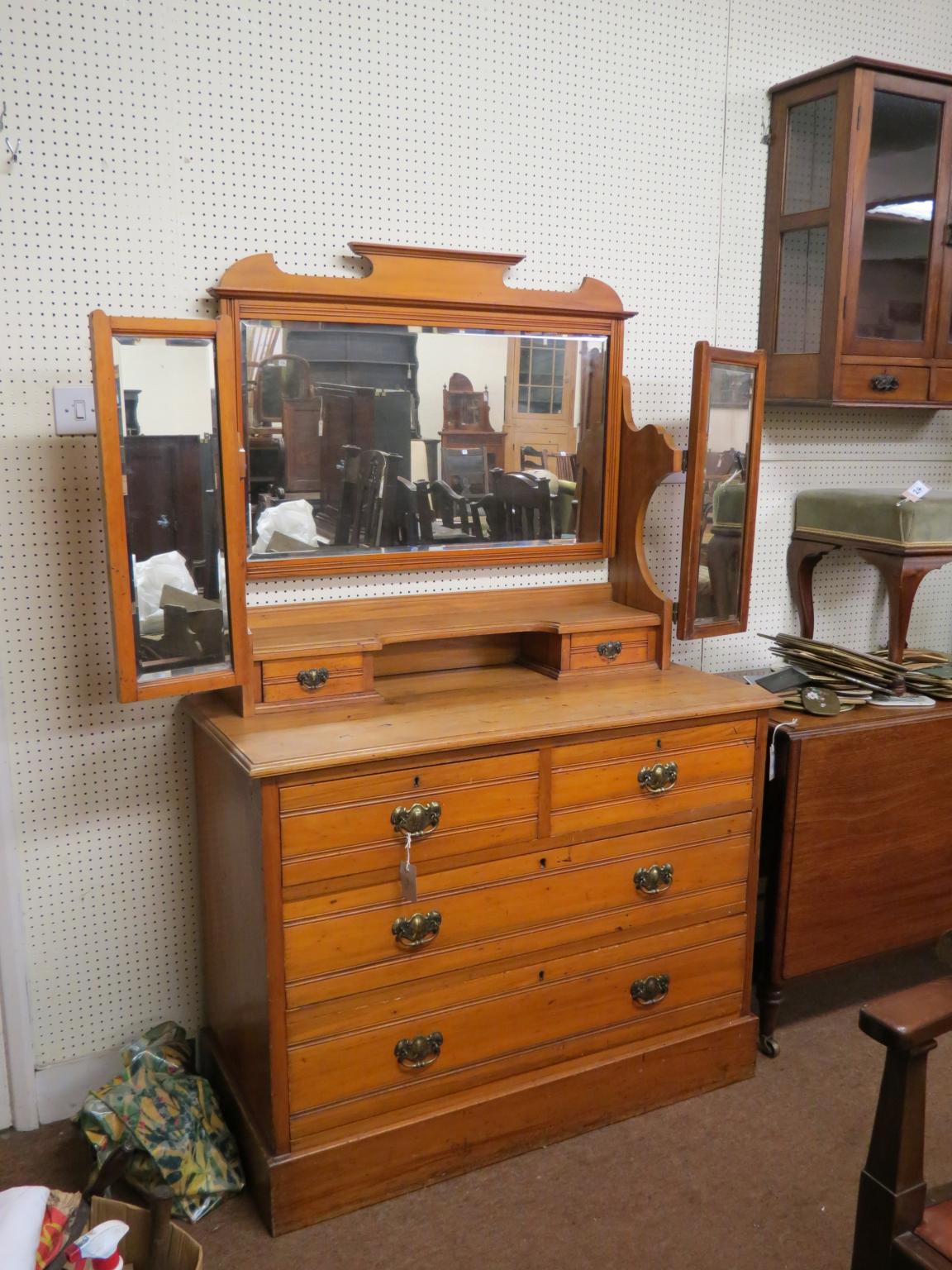 Appraisal: A satin walnut dressing chest rectangular bevelled mirror adjustable above