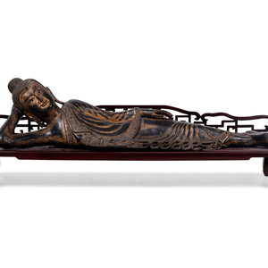 Appraisal: A Thai Gilt Decorated Black Lacquered Wood Figure of Reclining