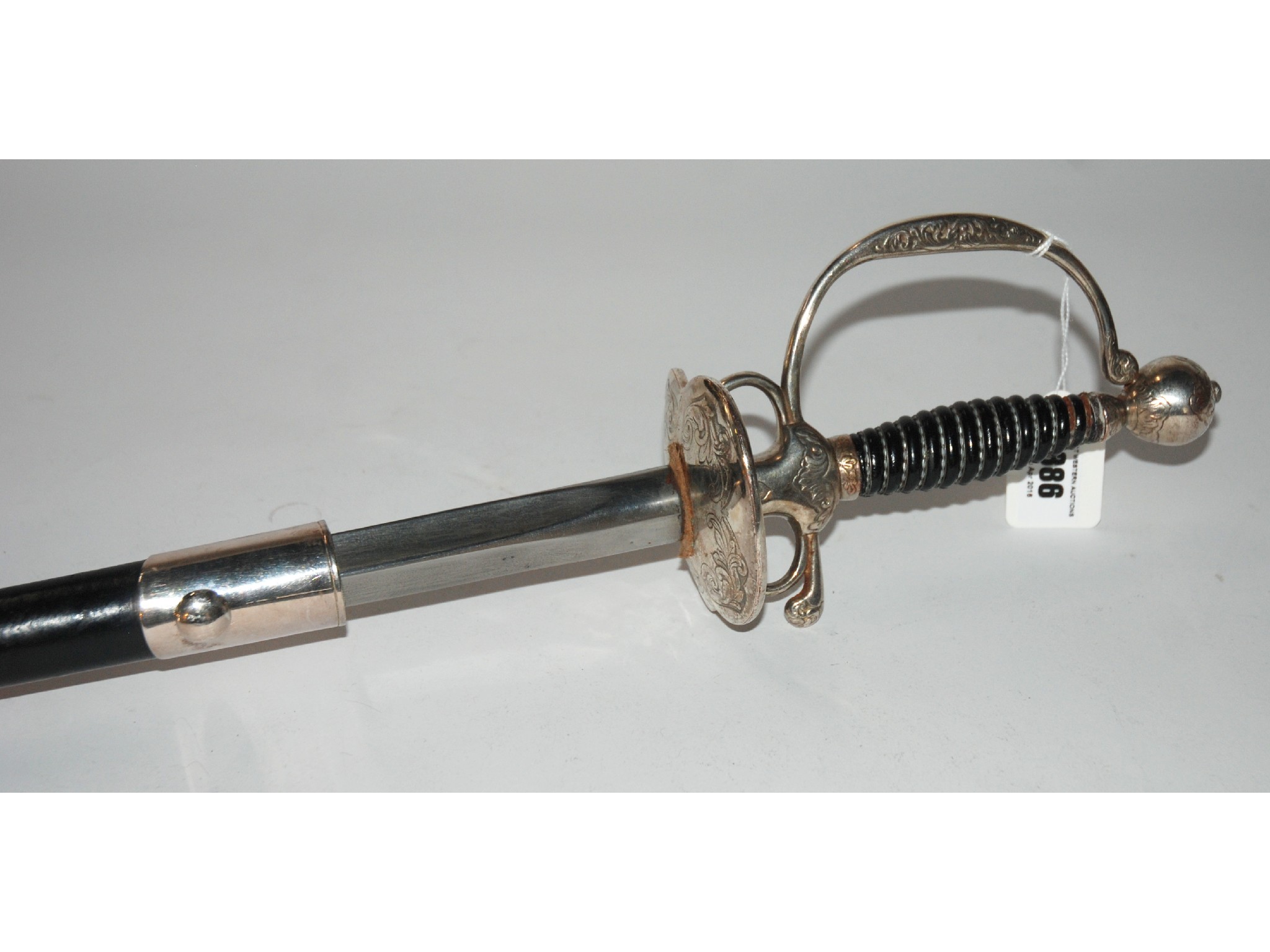 Appraisal: A reproduction rapier with engraved basket and hilt