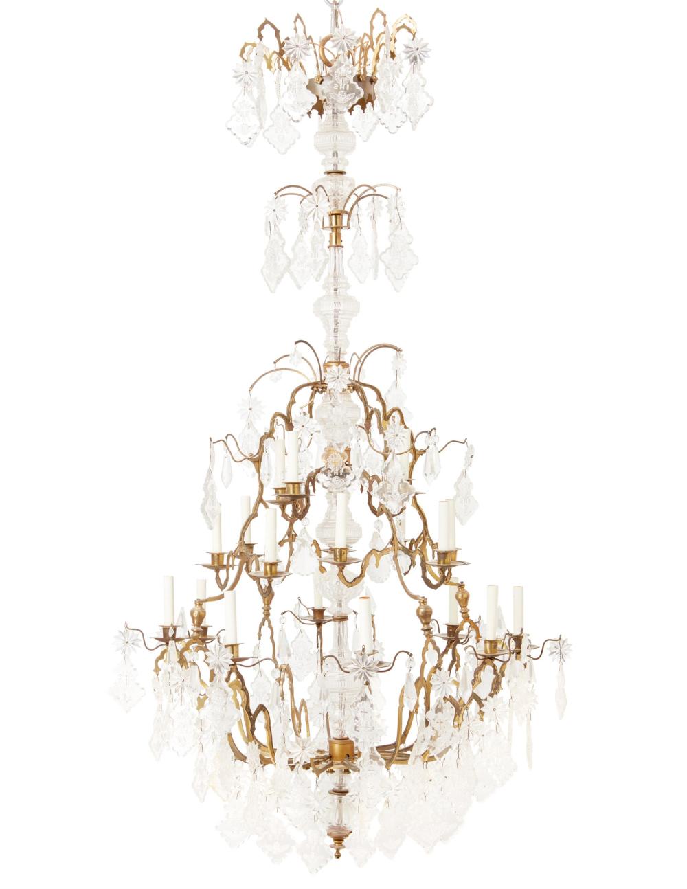 Appraisal: A bronze and crystal chandelier th st Century The twenty-light