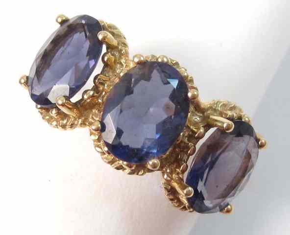 Appraisal: IOLITE AND TEN KARAT GOLD RING set with three oval-cut