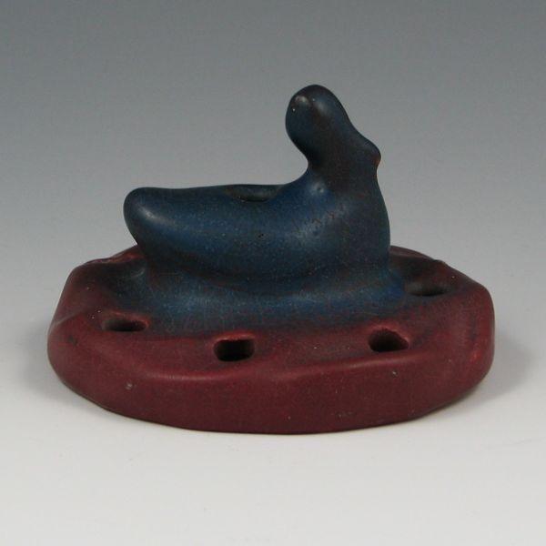 Appraisal: Van Briggle flower frog in mulberry glaze with swan figure