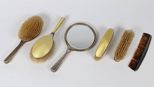 Appraisal: A SILVER YELLOW ENAMEL AND ENGINE TURNED BACKED DRESSING TABLE