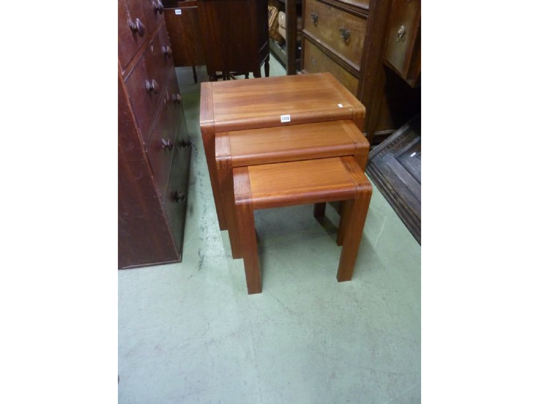 Appraisal: A set of three teakwood graduated occasional tables with exposed