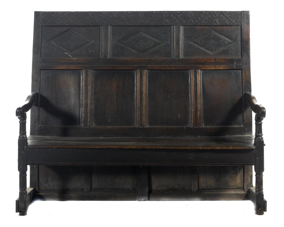 Appraisal: A CHARLES II JOINED OAK SETTLE the panelled back crested