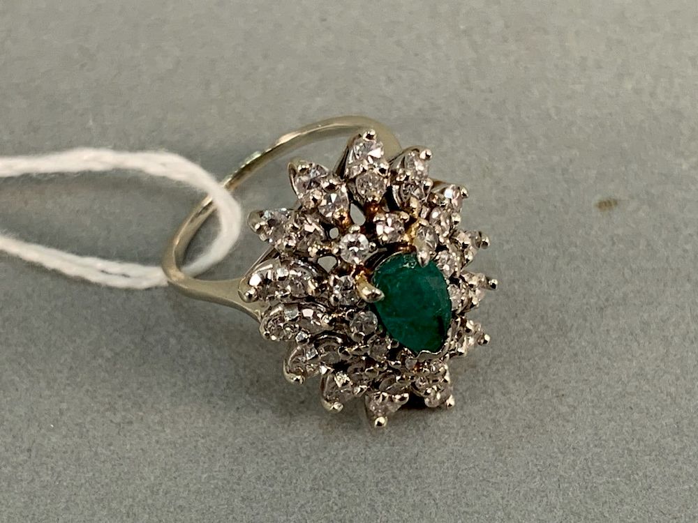 Appraisal: k white gold cocktail ring set with center emerald surrounded