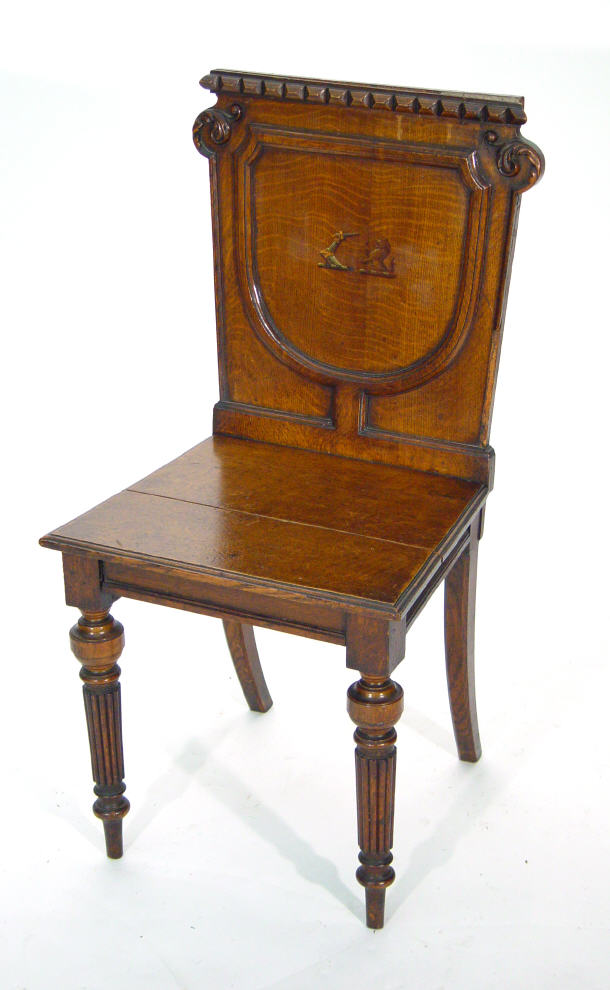 Appraisal: Victorian oak hall chair with shield design back painted coat