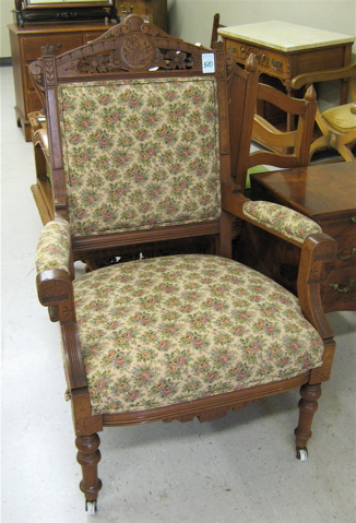 Appraisal: VICTORIAN WALNUT ARMCHAIR Eastlake design American c with floral tapestry