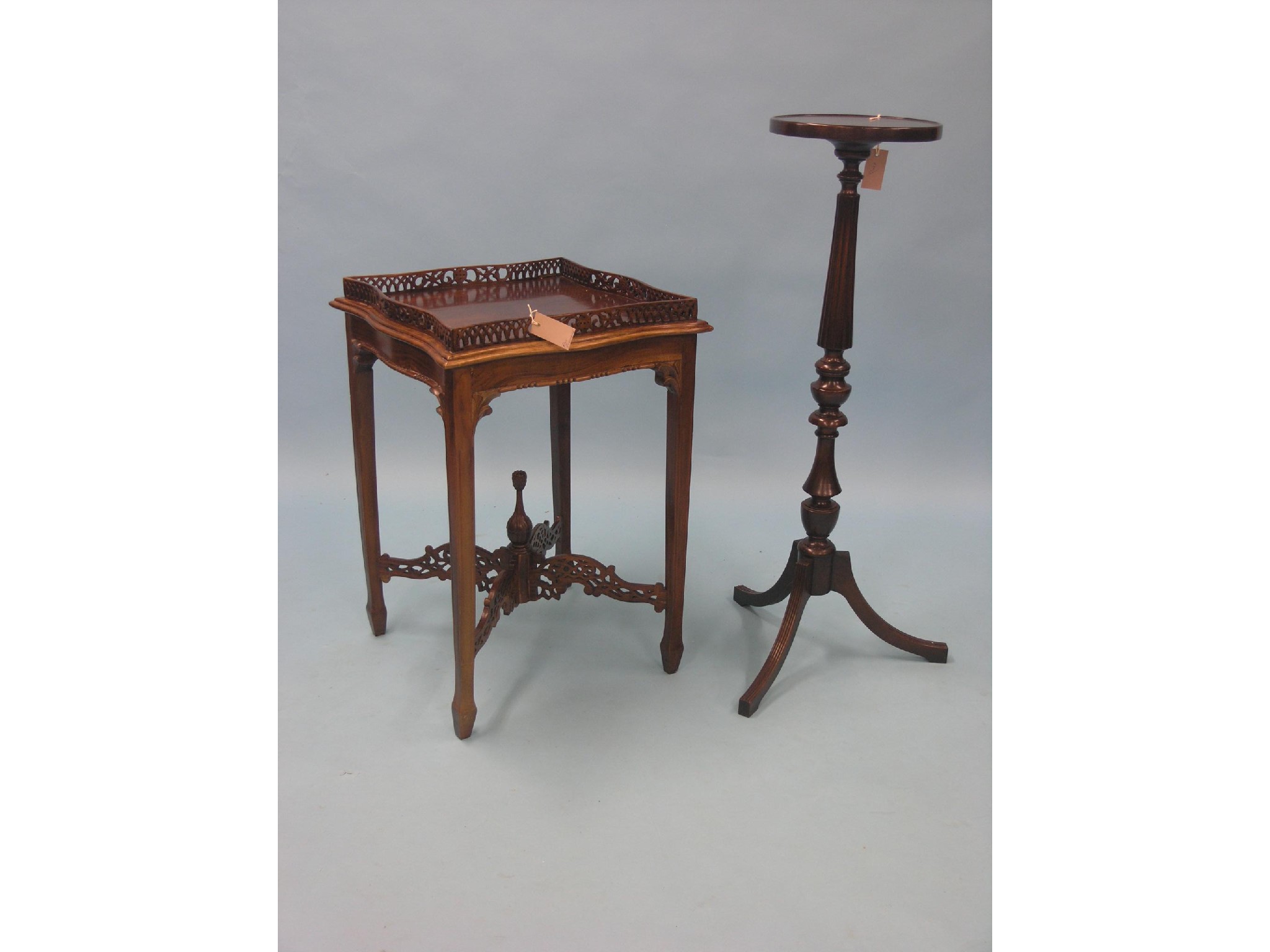 Appraisal: A Victorian-style mahogany occasional table serpentine-shaped top with pierced gallery