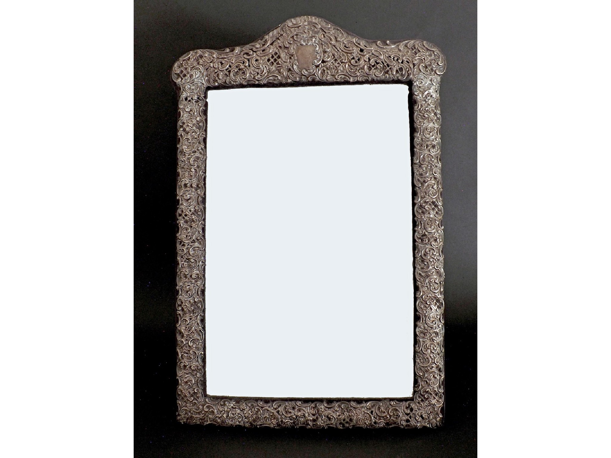 Appraisal: Edwardian silver mounted bevel edged easel mirror embossed with scrolling