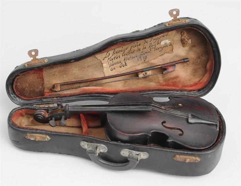 Appraisal: MINIATURE VIOLIN AND BOW WITH LEATHER-BOUND CASE The case with