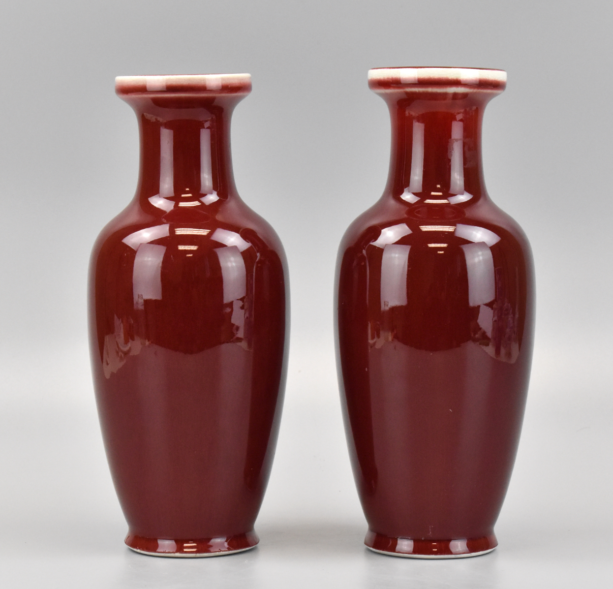 Appraisal: A pair of Chinese red glazed vases 's Glossy deep