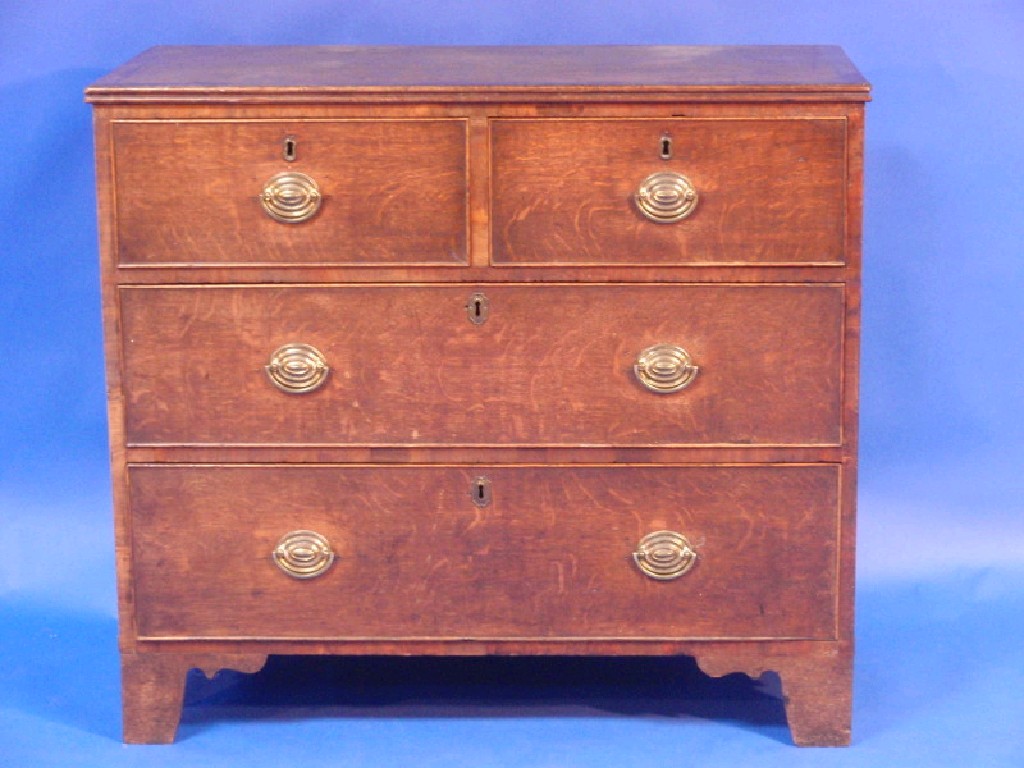 Appraisal: A Georgian oak cross banded chest of two short and