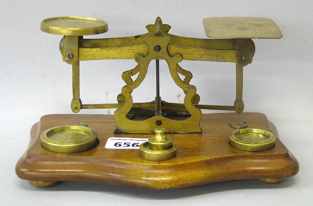 Appraisal: Pair of small brass postal scales upon a serpentine mahogany