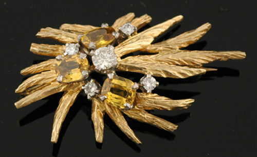 Appraisal: A diamond and sapphire cocktail brooch The abstract design with