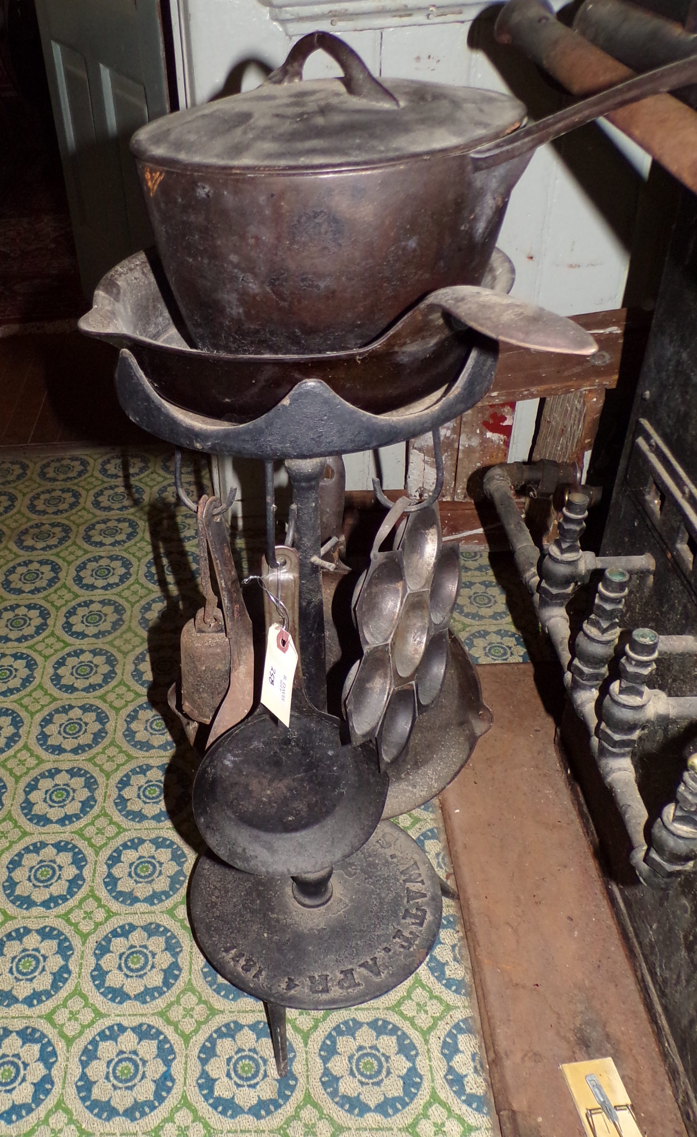 Appraisal: S Watt cast iron stand with several kitchen implements ''h