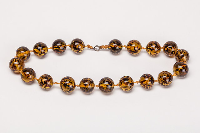 Appraisal: A light brown round glass bead necklace the glass beads