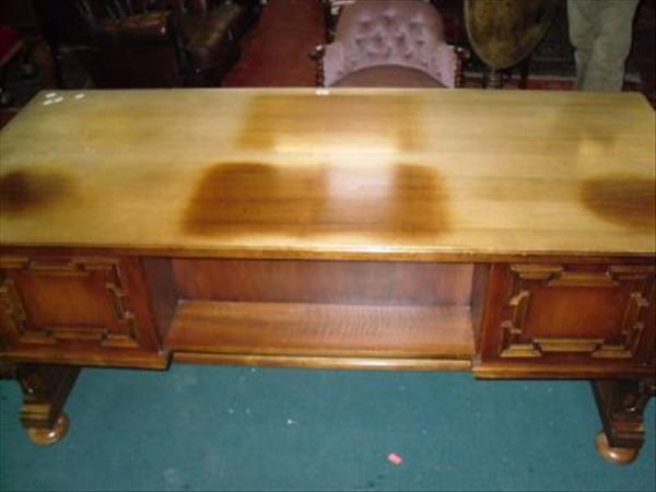 Appraisal: A large continental walnut desk with moulded decoration