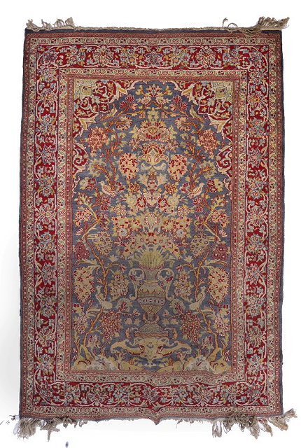 Appraisal: A PERSIAN STYLE BLUE GROUND PICTORIAL RUG decorated a central