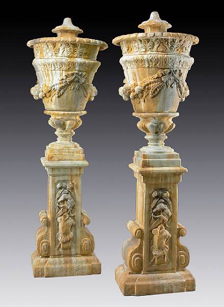 Appraisal: A pair of Neoclassical style composition covered urns th century