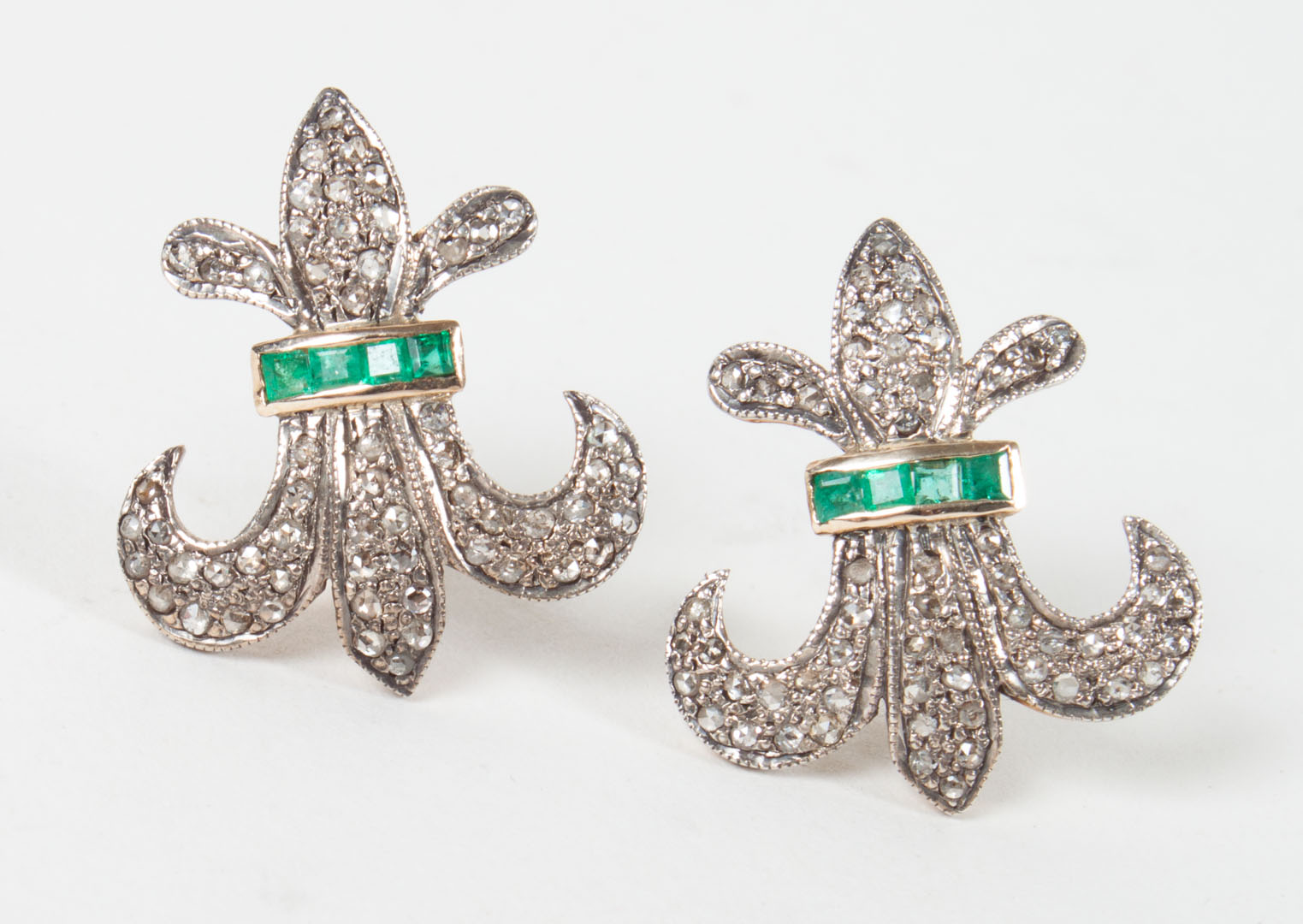 Appraisal: Pair of fleur-de-lis diamond emerald earrings unmarked gold tests as