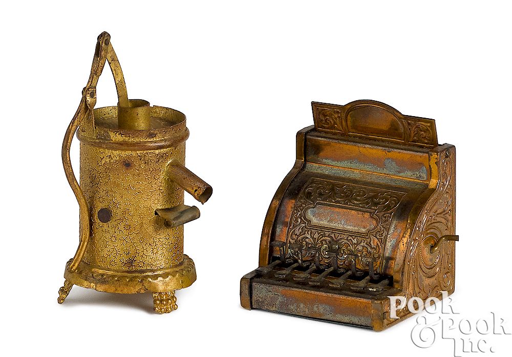 Appraisal: Cash register and water pump figural tape measure Embossed brass